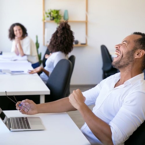 Picture of a group of people in an office laughing